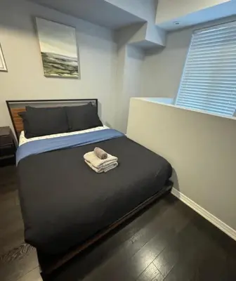 a bedroom with a bed with a towel on it at apartment for 4 guests in Port Hope
