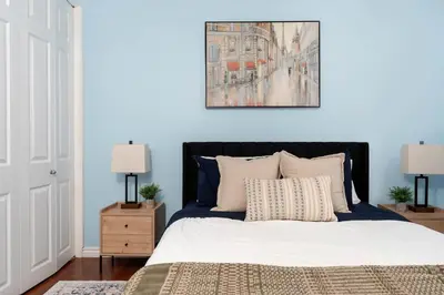 a bedroom with a bed and a painting on the wall at House with 5 Beds for Families in Great Location in Mississauga