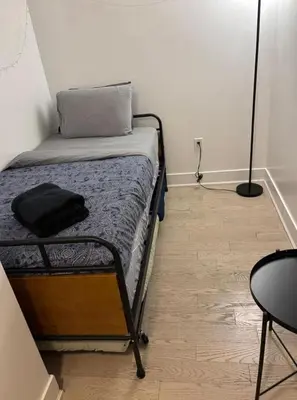a bedroom with a bed with a pillow and a table at Apartment for 4 trundle Bay in Port Hope