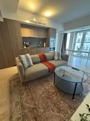 a living room with a couch and a glass table at Apartment for 4 trundle Bay in Port Hope