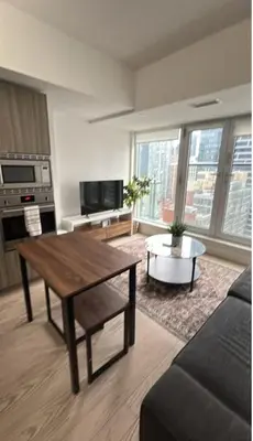 a living room with a couch and a table at Nice view apartment office den in Port Hope