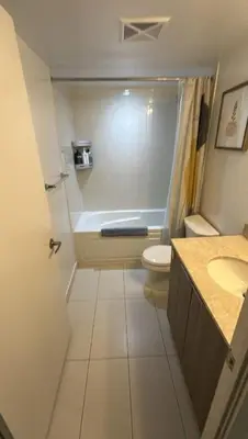 a bathroom with a tub and a toilet and a sink at Nice view apartment office den in Port Hope