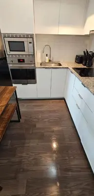 a kitchen with a sink and a stove top oven at Queen Bed and single bed for friends in Port Hope