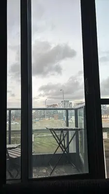 a window with a table and a view of a field at apartment for 2 by water in St. Catharines