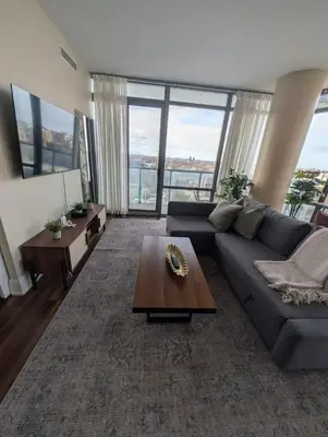 a living room with a couch and a table at Nice Place Central to Downtown in St. Catharines