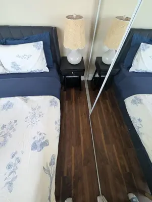 a room with two beds and two lamps on tables at Nice Place Central to Downtown in St. Catharines