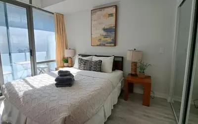 a bedroom with a bed with a towel on it at Functional Condo Sleep 6 in Port Hope