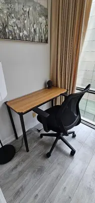 a desk with a black office chair in front of a window at Functional Condo Sleep 6 in Port Hope
