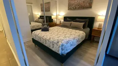 a bedroom with a bed with a lamp on it at Functional Condo Sleep 6 in Port Hope