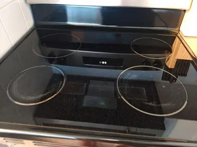 a black oven with two pans on top of it at Small Apartment for 2 in St. Catharines