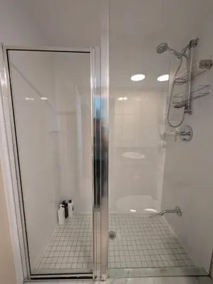 a shower with a glass door in a bathroom at Small Apartment for 2 in St. Catharines