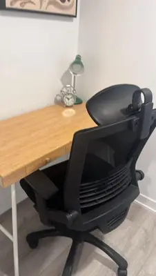 a black office chair sitting at a wooden desk at Sleep 2 guests cozy couch in Port Hope