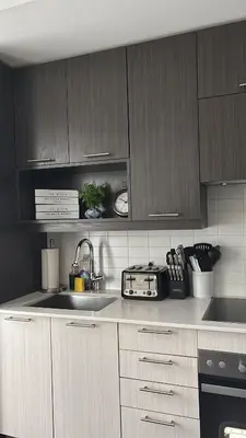 a kitchen with wooden cabinets and a sink and a stove at Modern Group Condo in Port Hope