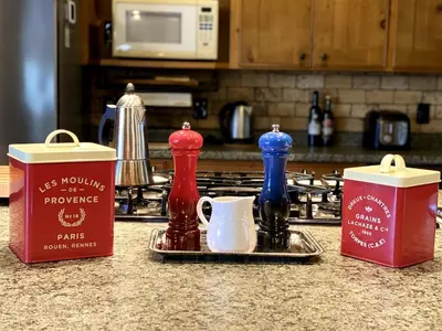 a kitchen counter with condiments on a counter top at Cajun Cabin Private Nature Resort in Minden