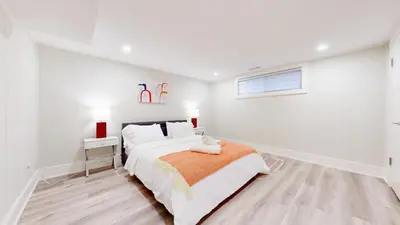 a white bedroom with a bed and a window at 5 Bedroom Luxury Spa Escape with Pool & Jacuzzi in Toronto