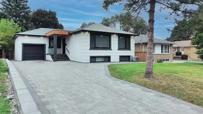 a house with a driveway in front of it at 5 Bedroom Luxury Spa Escape with Pool & Jacuzzi in Toronto
