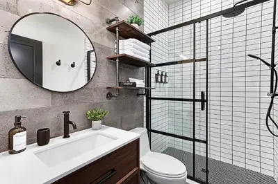 a bathroom with a sink and a toilet and a mirror at The Brick & Beam Boutique Hotel in Collingwood