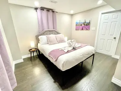 a bedroom with a bed with a teddy bear on it at Violet Escape Modern Apt 1B 1B, Kitchen, Parking in Richmond Hill