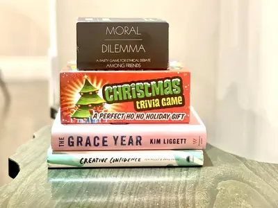 three books stacked on top of each other on a table at Violet Escape Modern Apt 1B 1B, Kitchen, Parking in Richmond Hill