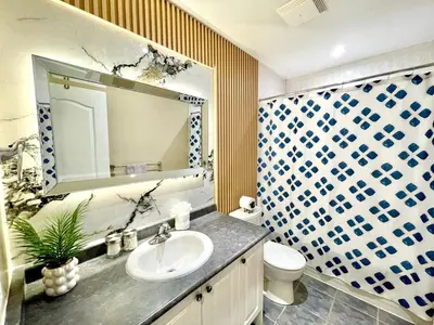 a bathroom with a sink and a toilet and a mirror at Paris Charm Modern 4B3B, Kitchen, Parking,5G in Richmond Hill