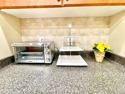 a kitchen with a toaster oven on a counter at Paris Charm Modern 4B3B, Kitchen, Parking,5G in Richmond Hill