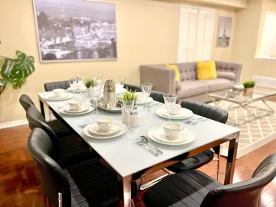 a dining room table with chairs and a white table and chairsktop at Paris Charm Modern 4B3B, Kitchen, Parking,5G in Richmond Hill