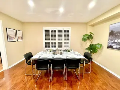 a dining room with a table and chairs at Paris Charm Modern 4B3B, Kitchen, Parking,5G in Richmond Hill