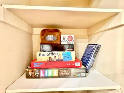 a stack of books sitting on a shelf at Paris Charm Modern 4B3B, Kitchen, Parking,5G in Richmond Hill