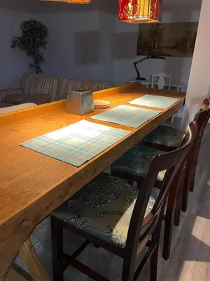 a wooden dining room table with four chairs around it at Deluxe Country Escape-Entire Basement Unit in Hamilton