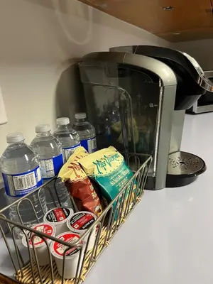 a basket of food and water in front of a microwave at Deluxe Country Escape-Entire Basement Unit in Hamilton