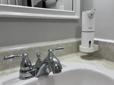 a bathroom sink with a faucet and a mirror at Deluxe Country Escape-Entire Basement Unit in Hamilton