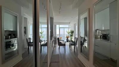 a kitchen and dining room with a table and chairs at Prestige Upper Series 1-Bedroom Condo at Vaughan Metropolitan Centre in Vaughan