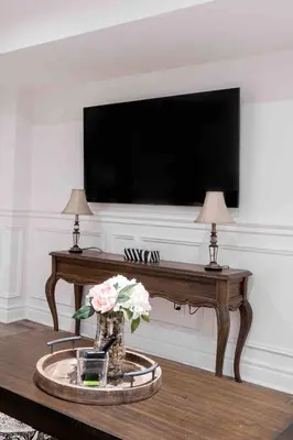a living room with a tv and a table with flowers at Luxury 2 Bedroom 2Bathroom Modern B Apartment in Ajax, Toronto in Ajax