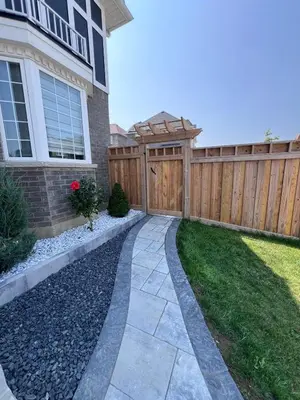 a wooden fence in a yard next to a house at Luxury 2 Bedroom 2Bathroom Modern B Apartment in Ajax, Toronto in Ajax