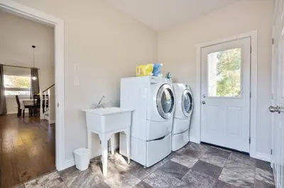a laundry room with a washing machine and a sink at Cozy Couple Retreat | 2 BDR APT | BBQ in Kawartha Lakes