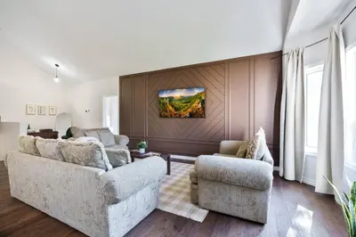 a living room with two couches and a wall at Cozy Couple Retreat | 2 BDR APT | BBQ in Kawartha Lakes