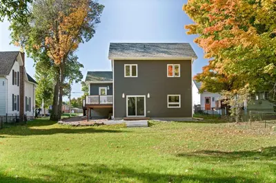 a house in a yard with trees and grass at Cozy Couple Retreat | 2 BDR APT | BBQ in Kawartha Lakes