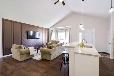 a kitchen and living room with chairs and a table at Cozy Couple Retreat | 2 BDR APT | BBQ in Kawartha Lakes