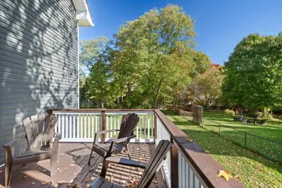 two chairs sitting on the deck of a house at Cozy Couple Retreat | 2 BDR APT | BBQ in Kawartha Lakes