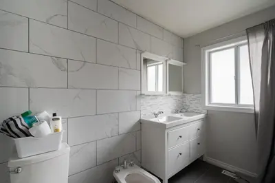 a white bathroom with a toilet and a sink at Spacious Bright Home In Woodbridge in Vaughan
