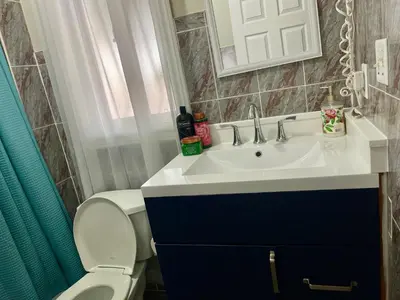a bathroom with a sink and a toilet and a mirror at Spacious Bright Home In Woodbridge in Vaughan