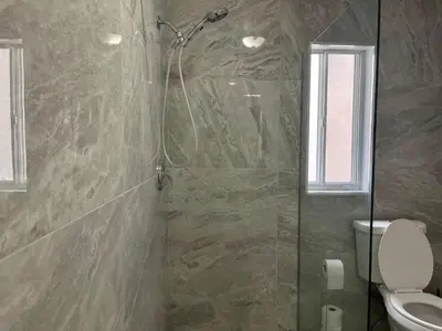 a bathroom with a shower and a toilet at Spacious Bright Home In Woodbridge in Vaughan