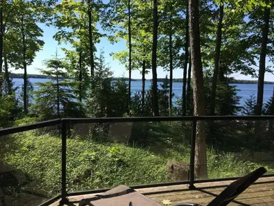 a view from the deck of a house with a view of the water at Lake Eugenia Escape - Cozy Lakefront with Hot Tub in Flesherton