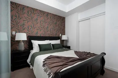 a bedroom with a large bed and a wall at Live the excitement Stay next to Scotiabank Arena! in Toronto