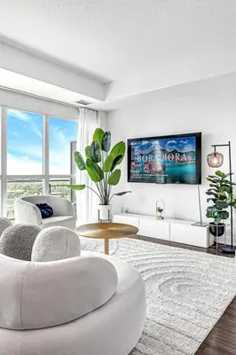 a living room with a couch and a table at Charming lakeview suite with parking in Toronto