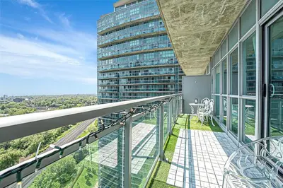 a balcony with a view of a tall building at Charming lakeview suite with parking in Toronto