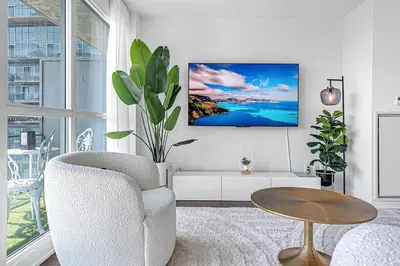 a living room with a chair and a table at Charming lakeview suite with parking in Toronto