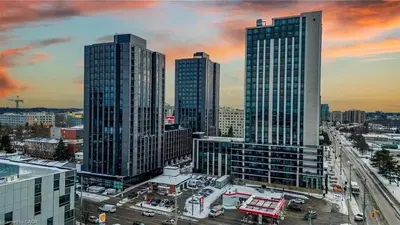 a city skyline with tall buildings and a fire truck at Cozy 2BD Near UW in Waterloo