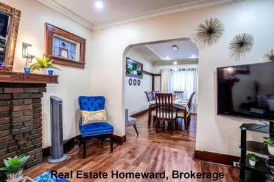 a living room with a fireplace and a tv at 132 chatham ave in Toronto