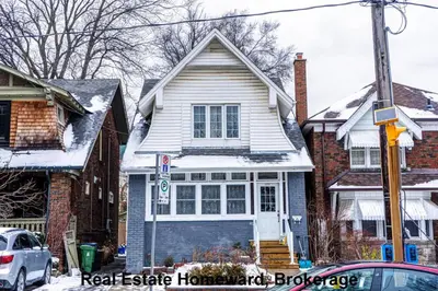 a white house with snow on top of it at 132 chatham ave in Toronto